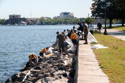 Teams of volunteers spread out to pick up trash along the shoreline near Naval Medical Center Portsmouth during Clean the Base Day activities at the Naval Support Activity Hampton Roads Portsmouth Annex May, 5