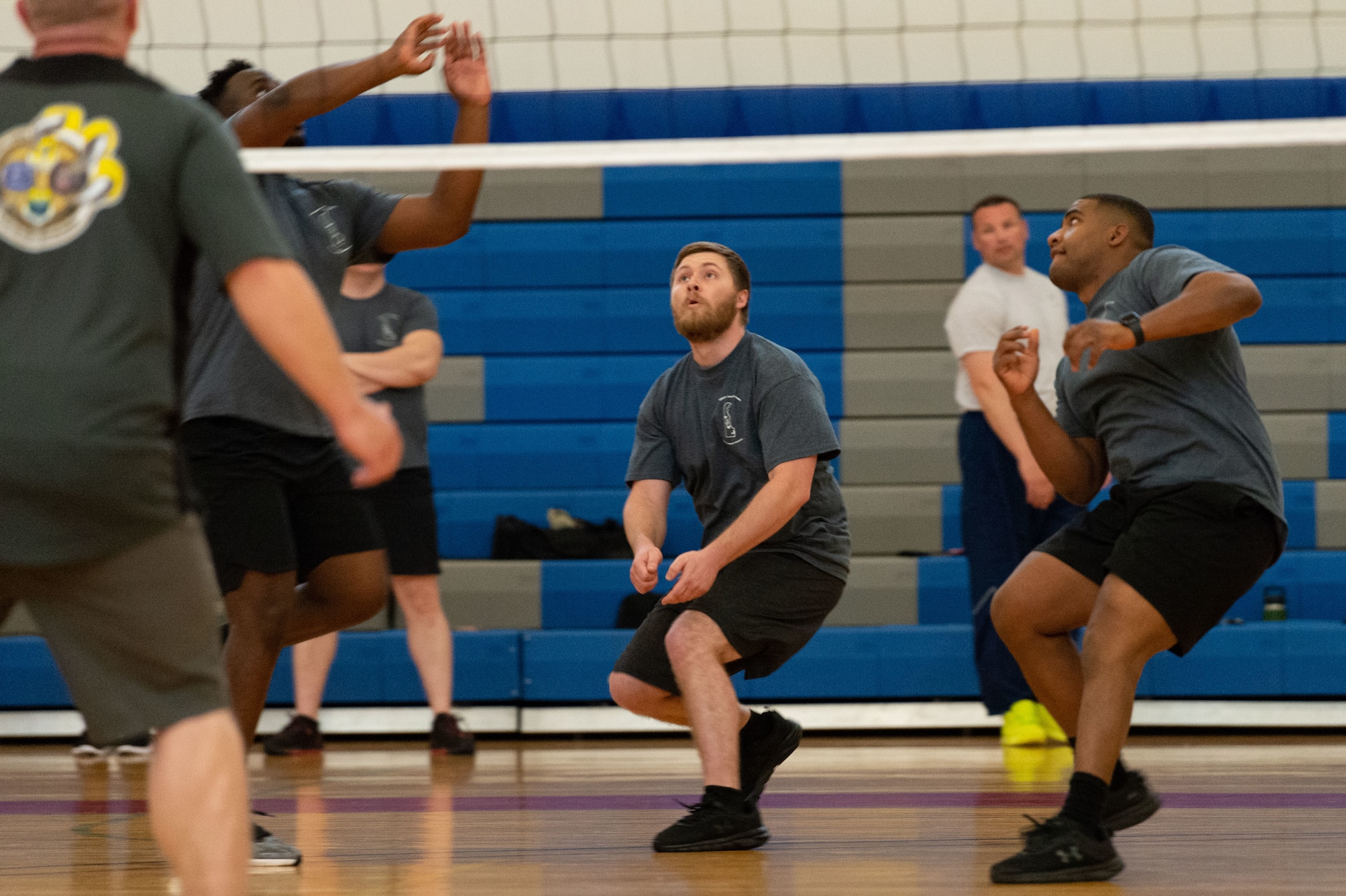Dillon Lackus, center, Air Force Mortuary Affairs Operations mortuary clerk, gets in position during a volleyball game played between the Staff Sgt. Julio Alonso Airman Leadership School, Class 23-E, students versus commanders and first sergeants at the Fitness Center on Dover Air Force Base, Delaware, April 24, 2023. Lackus was the first civilian Airman to graduate from the Staff Sgt. Julio Alonso ALS. (U.S. Air Force photo by Roland Balik)