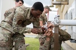 Airman 1st Class Cahleel Gentillon, a heating, ventilation, air conditioning specialist with the 157th Civil Engineer Squadron, New Hampshire Air Nationbal Guard, teaches Airman 1st Class Isaac Dargan, an HVAC specialist with the 35th CES, how to flare tubing on a heating unit May 11, 2023, at the Draughon Bombing Range, Misawa Air Base, Japan. The two teams integrated and trained one another while removing a faulty mini-split heating unit and installing a new model.