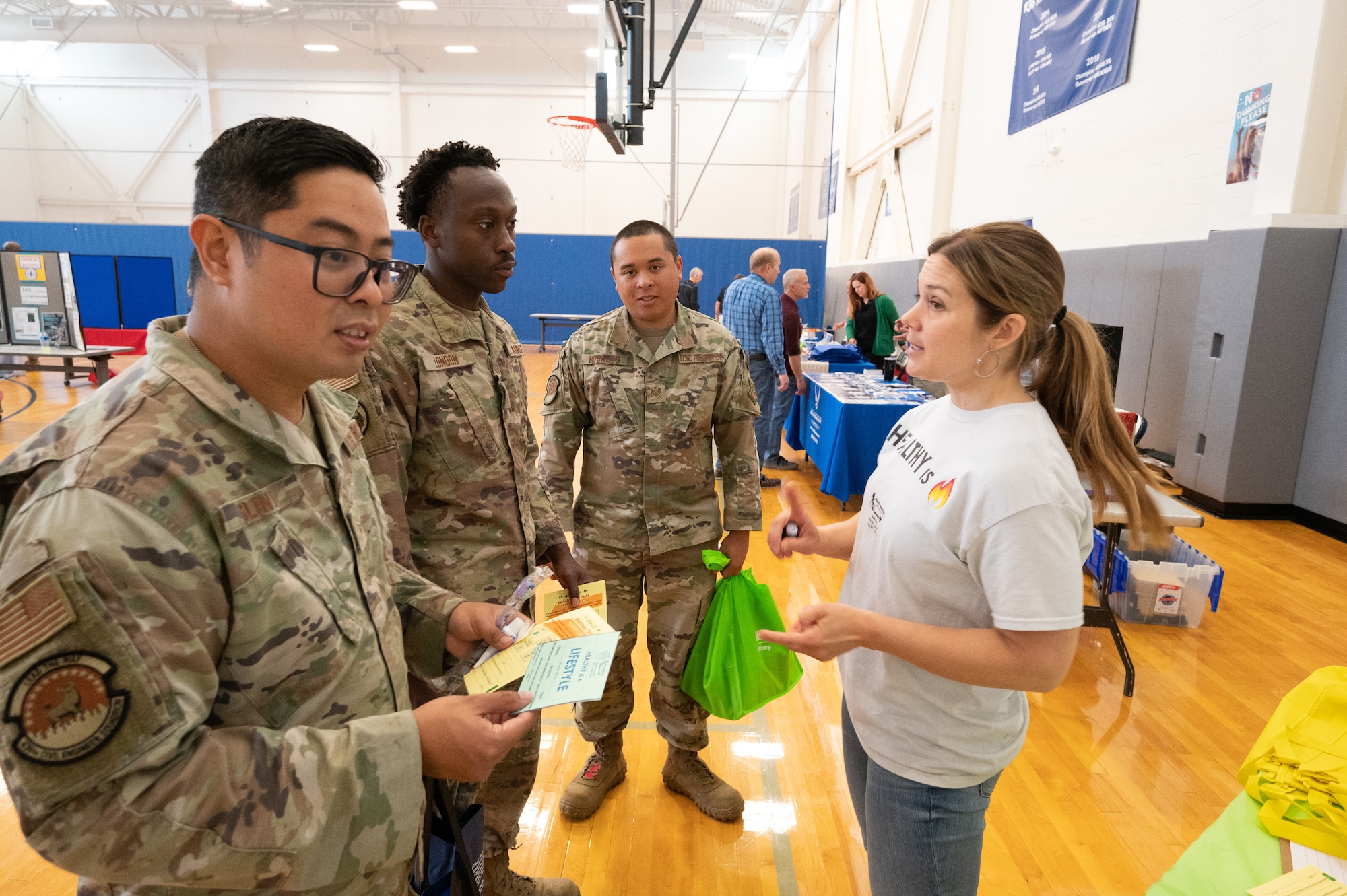 Kelly Dixon, right, 436th Operational Medical Readiness Squadron Health Promotions coordinator, speaks with Airmen of the 436th Civil Engineer Squadron about nutritionist services during the 436th CES Wellness Fair at Dover Air Force Base, Delaware, May 24, 2023. A total of 28 military and civilian organizations set up booths to address physical and mental health concerns and offer information on resources available. (U.S. Air Force photo by Mauricio Campino)