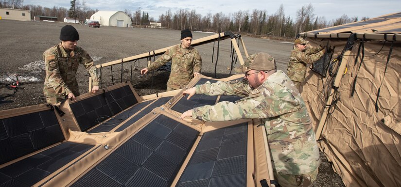 U.S. Air Force water and fuel systems maintenance personnel assigned to 773rd Civil Engineer Squadron, lay out a solar panel system for an Agile Combat Employment air transportable clinic, during Northern Edge 23-1 at Joint Base Elmendorf-Richardson, Alaska, May 9, 2023.