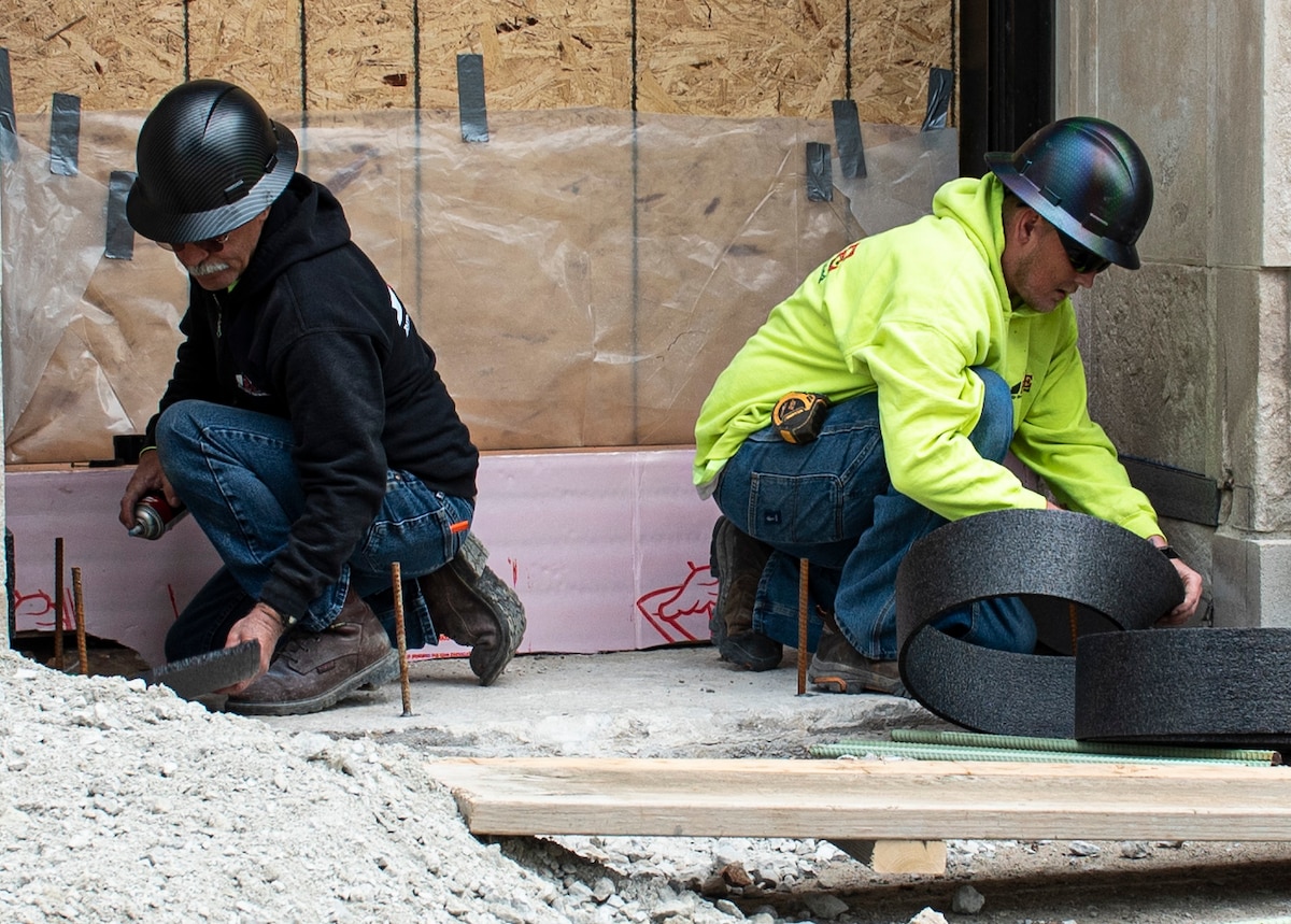 Carpenters works on renovating building entrance