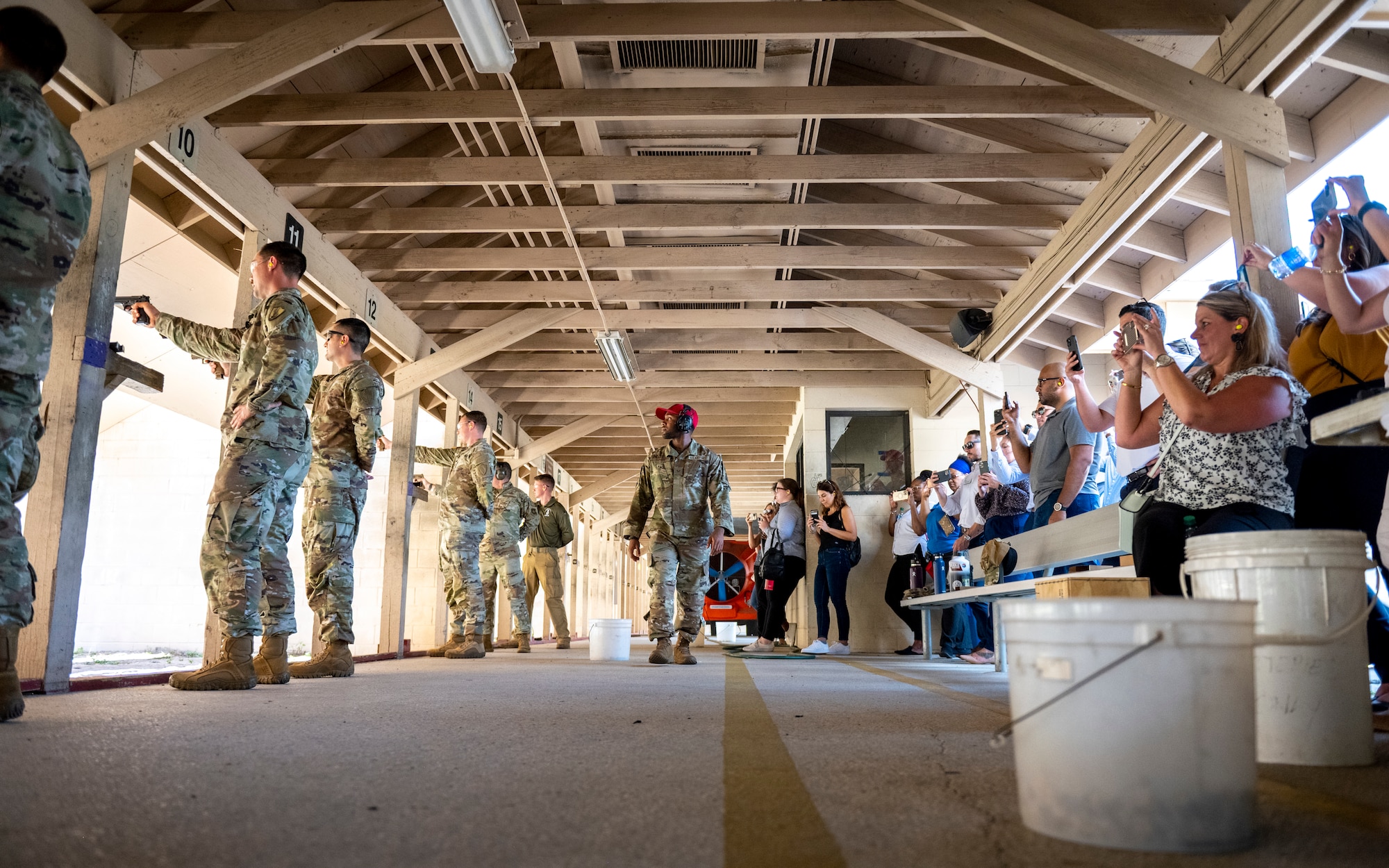 Civic leaders from the Tampa Bay Chamber Military Advisory Committee watch Airmen participate in an Excellence in Competition event at MacDill Air Force Base, Florida, May 18, 2023. The 6th Security Forces Squadron Combat Arms Training and Maintenance center hosted the competition in recognition of National Police Week while also providing some friendly competition and comradery. (U.S. Air Force photo by Senior Airman Lauren Cobin)