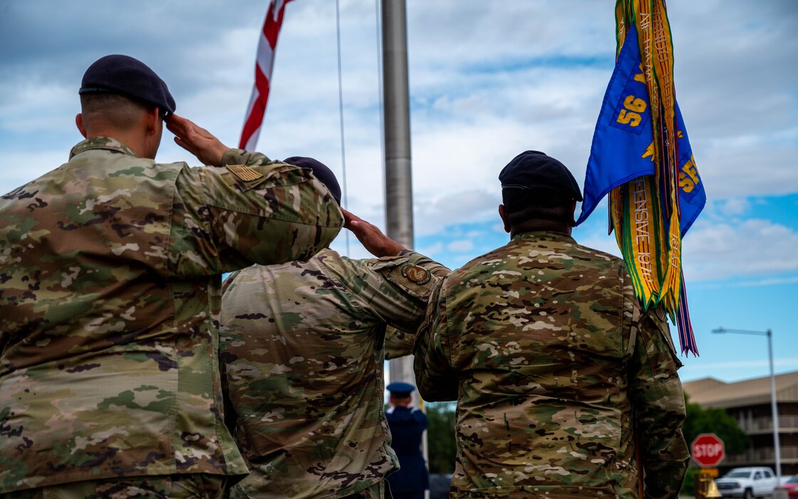 Members of the 56th Security Forces Squadron salute the U.S. flag as it is lowered, May 19, 2023, at Luke Air Force Base, Arizona.