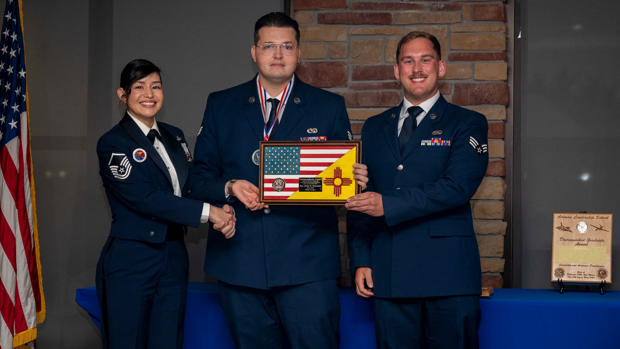 U.S. Air Force Aidan Simmons, Airman Leadership School graduate, accepts the Commandants Award during the graduation of ALS Class 23-E at Holloman Air Force Base, New Mexico, May 24, 2023.