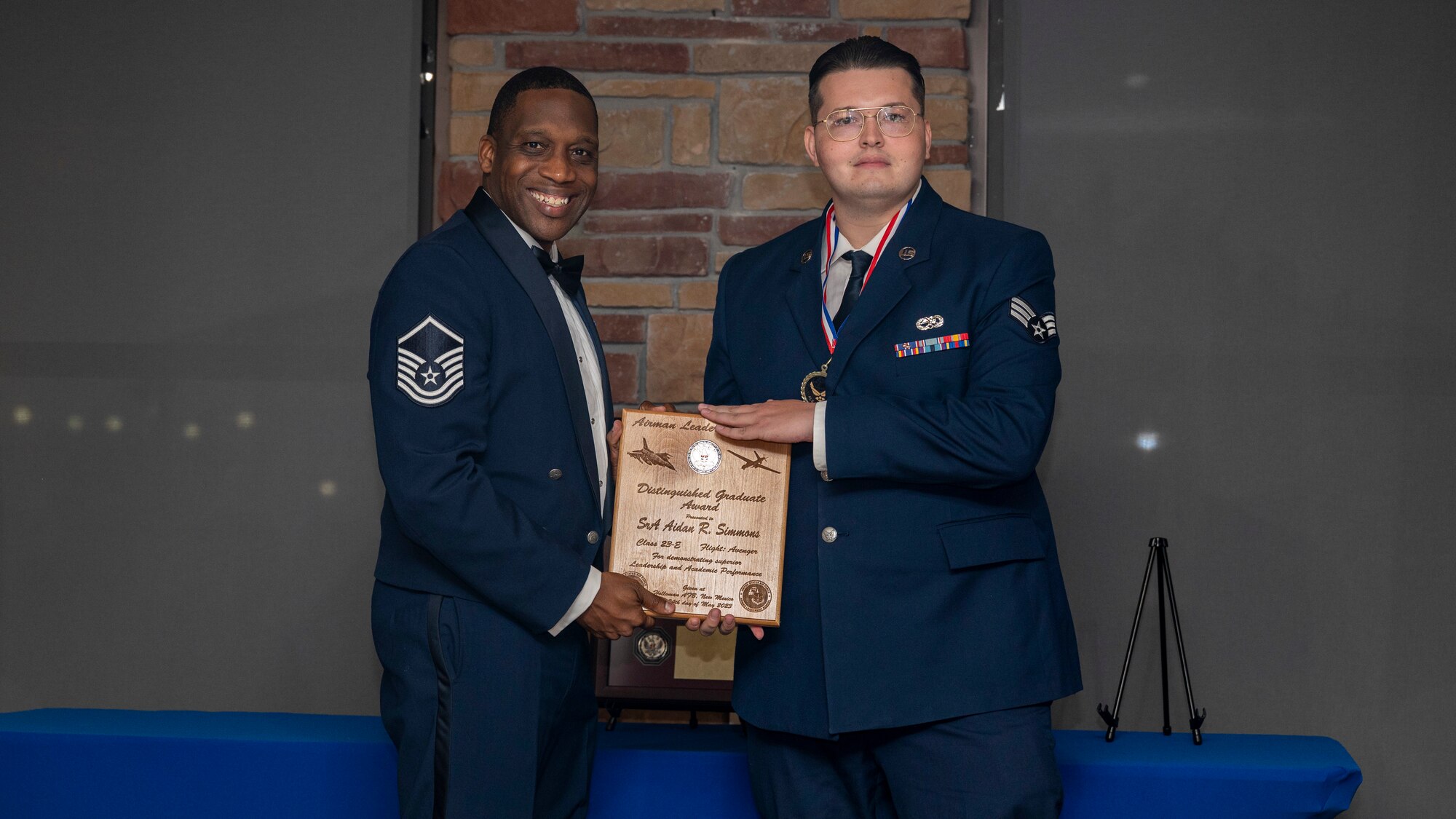 U.S. Air Force Senior Airman Aidan Simmons, Airman Leadership Graduate, accepts the Distinguished Graduate Award during the graduation of ALS Class 23-E at Holloman Air Force Base, New Mexico, May 24, 2023.