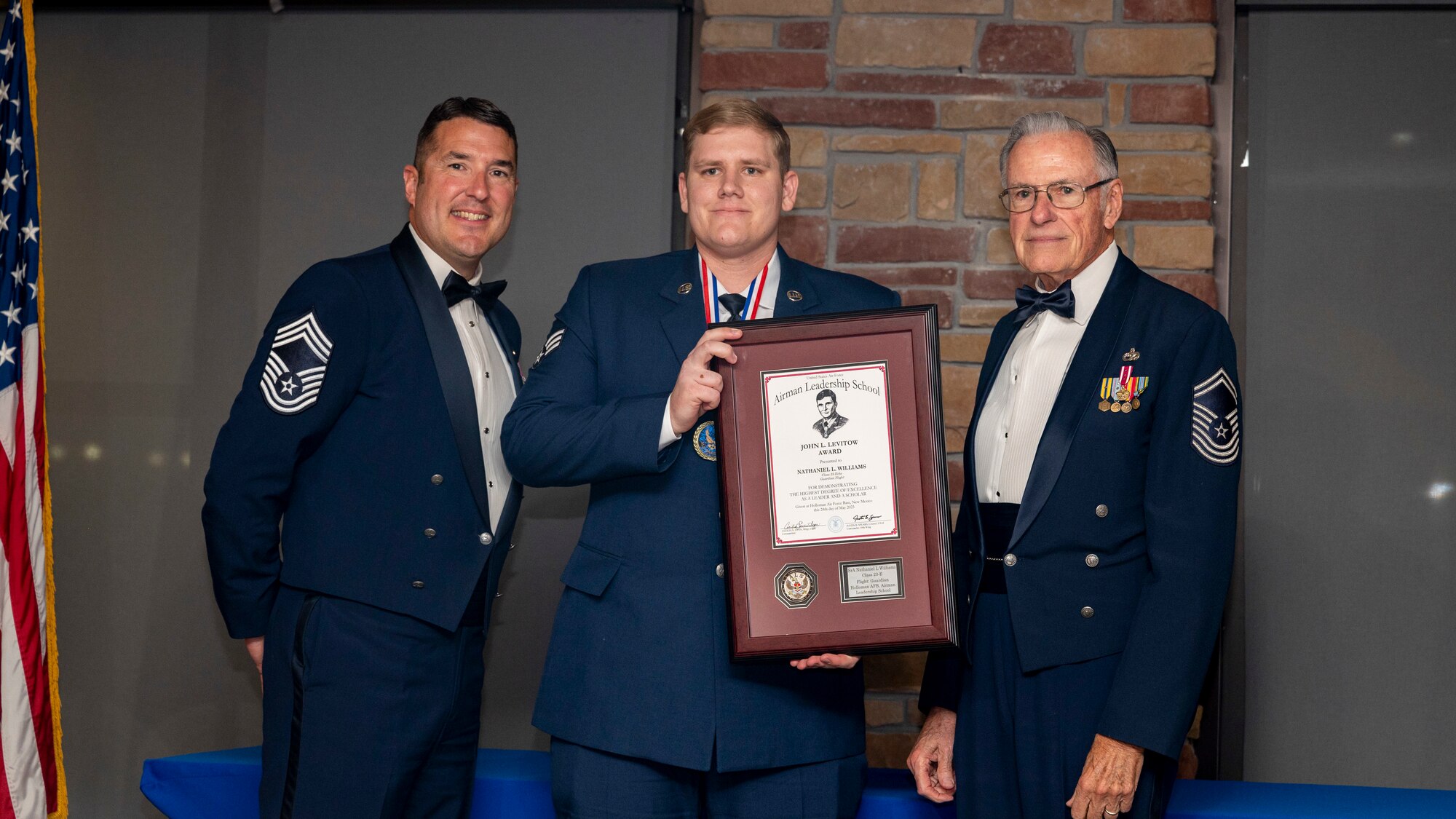 U.S. Air Force Senior Airman Nathaniel Williams, Airman Leadership Graduate, accepts the John L. Levitow Award during the graduation of ALS Class 23-E at Holloman Air Force Base, New Mexico, May 24, 2023.
