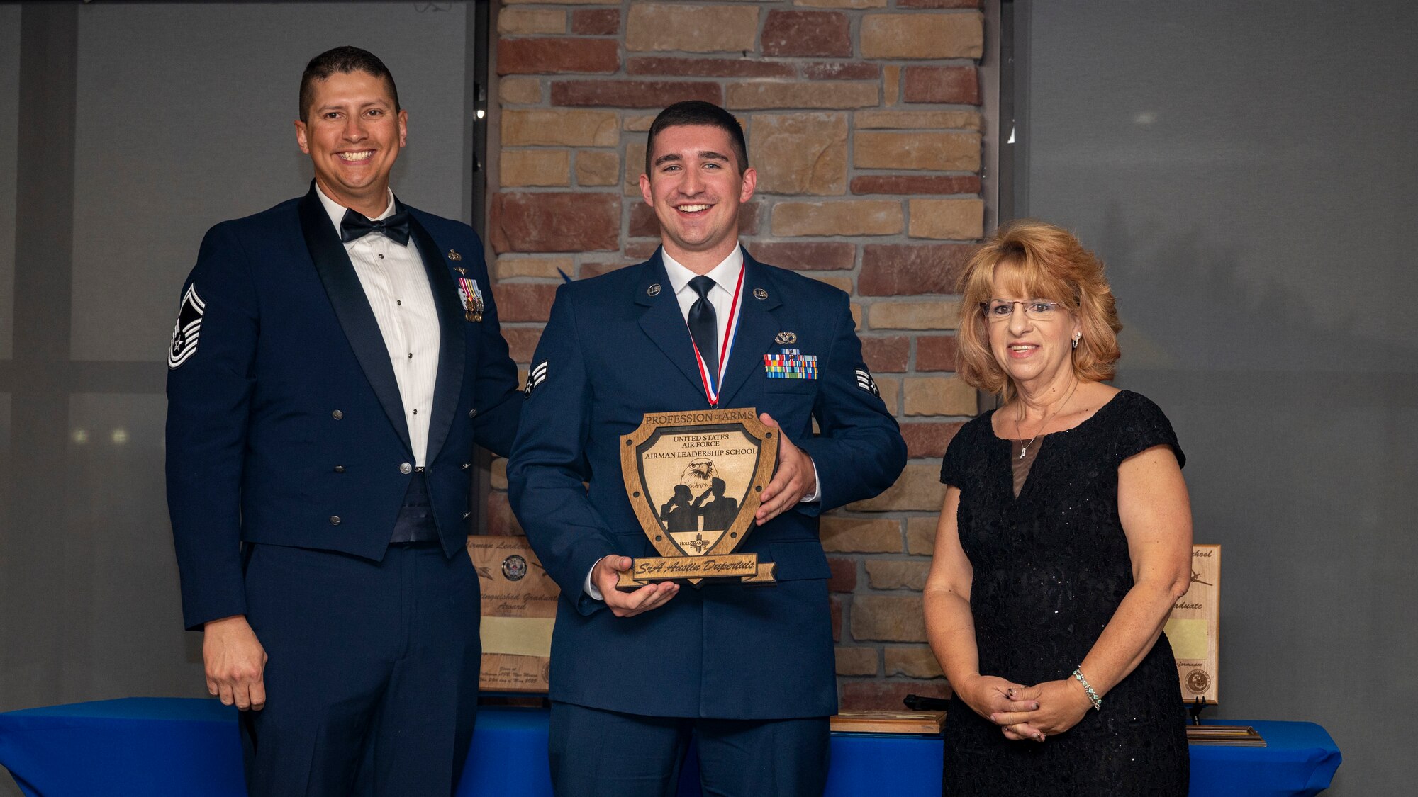 U.S. Air Force Senior Airman Austin Dupertuis, Airman Leadership Graduate, accepts the Profession of Arms Award during the graduation of ALS Class 23-E at Holloman Air Force Base, New Mexico, May 24, 2023.