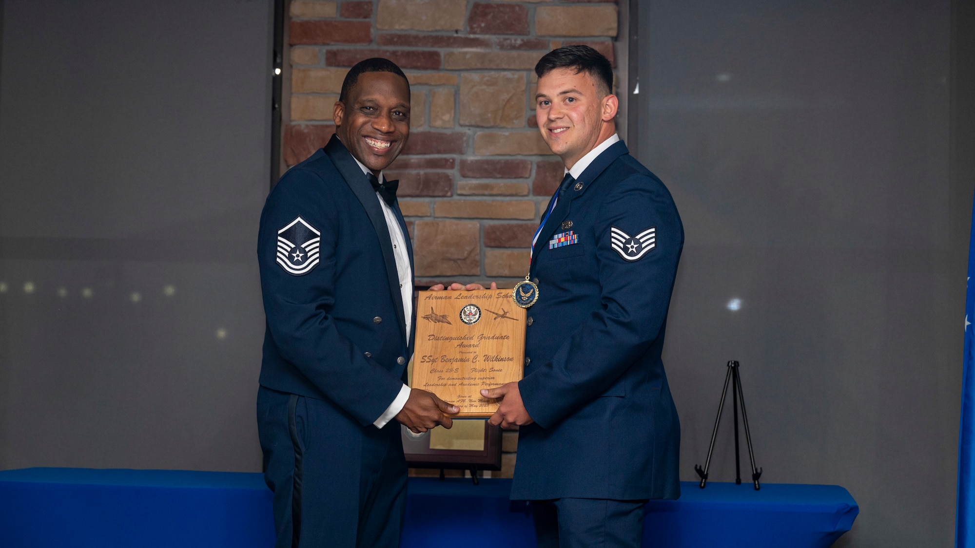 U.S. Air Force Staff Sgt. Benjamin Wilkinson, Airman Leadership Graduate, accepts the Distinguished Graduate Award during the graduation of ALS Class 23-E at Holloman Air Force Base, New Mexico, May 24, 2023.