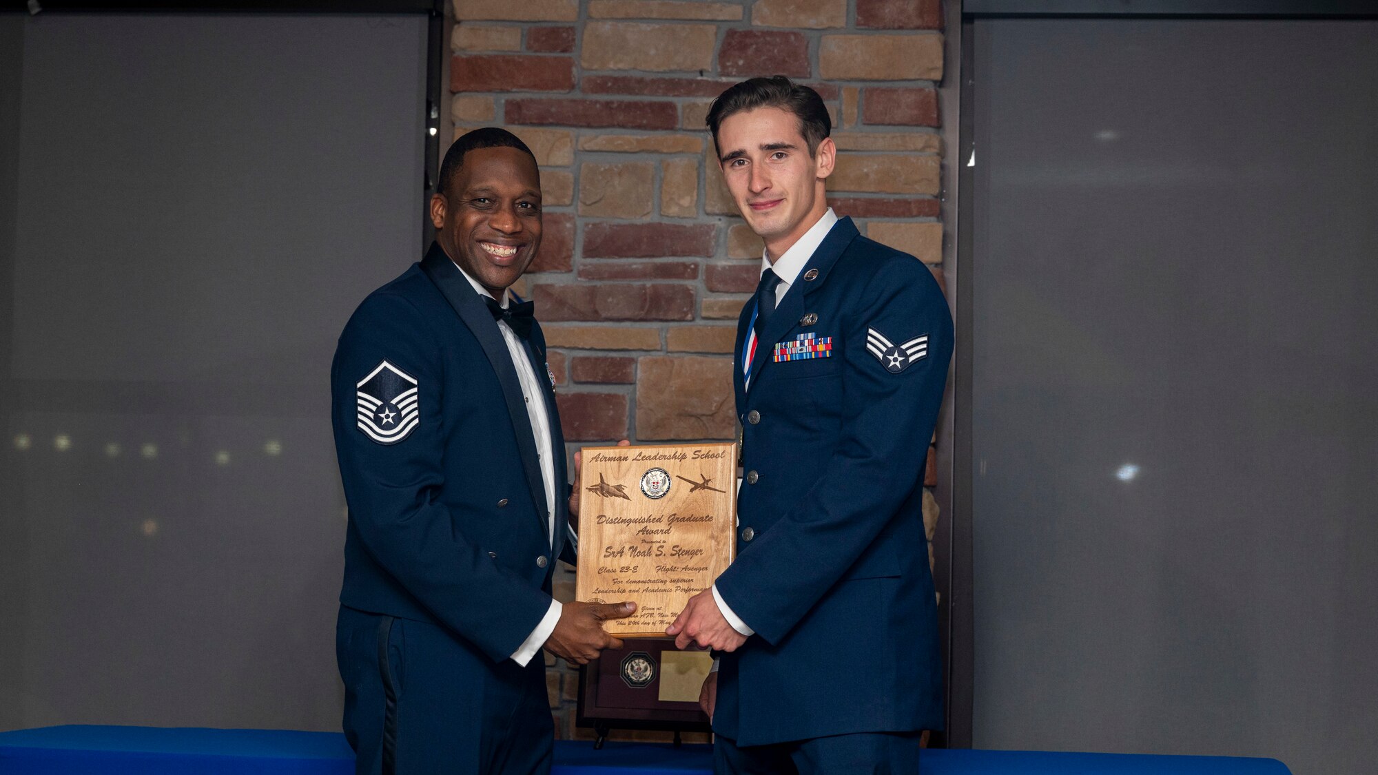 U.S. Air Force Senior Airman Noah Stenger, Airman Leadership Graduate, accepts the Distinguished Graduate Award during the graduation of ALS Class 23-E at Holloman Air Force Base, New Mexico, May 24, 2023.
