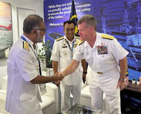 Adm. Samual Paparo, commander, U.S. Pacific Fleet, shakes hands with Rear Adm. Aminuddin Haji Abdul Rashid, director of maritime enforcement and coordination divison, Malaysian Maritime Enforcement Agency, while Vice Adm. Datuk Saiful Lizan Bin Inrahim, deputy director general for logistics, Malaysian Maritime Enforcement Agency, observes prior to a bilateral meeting at Langkawi International Maritime and Aerospace Exhibition 2023 in Langkawi, Malaysia, May 24, 2023. The visit to Malaysia underscored the United States’ commitment to strengthening alliances and partnerships for an enduring resilient, free and open Indo-Pacific. (Photo courtesy of U.S. Navy)