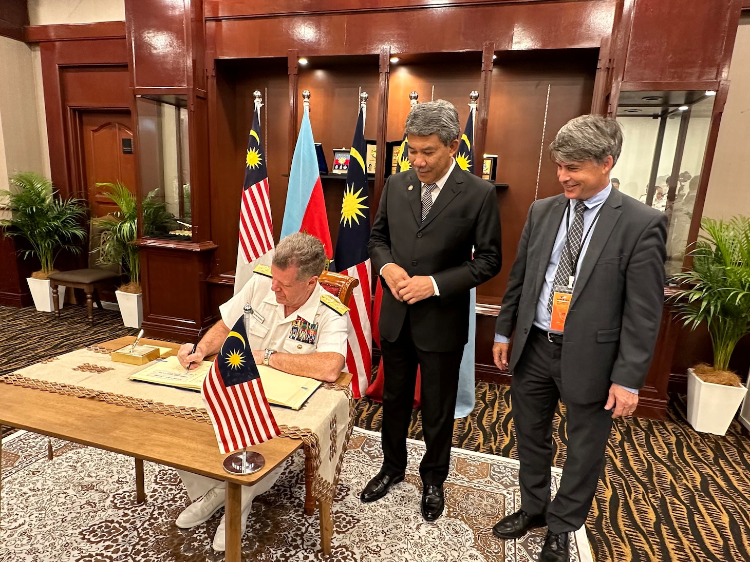 Adm. Samuel Paparo, commander, U.S. Pacific Fleet, signs a guest book with Malaysian Minister of Defence Mohamad Hasan, middle, and U.S. Ambassador to Malaysia Brian McFeeters at Langkawi International Maritime and Aerospace Exhibition 2023 in Langkawi, Malaysia, May 24, 2023. The visit to Malaysia underscored the United States’ commitment to strengthening alliances and partnerships for an enduring resilient, free and open Indo-Pacific. (U.S. Navy courtesy photo)