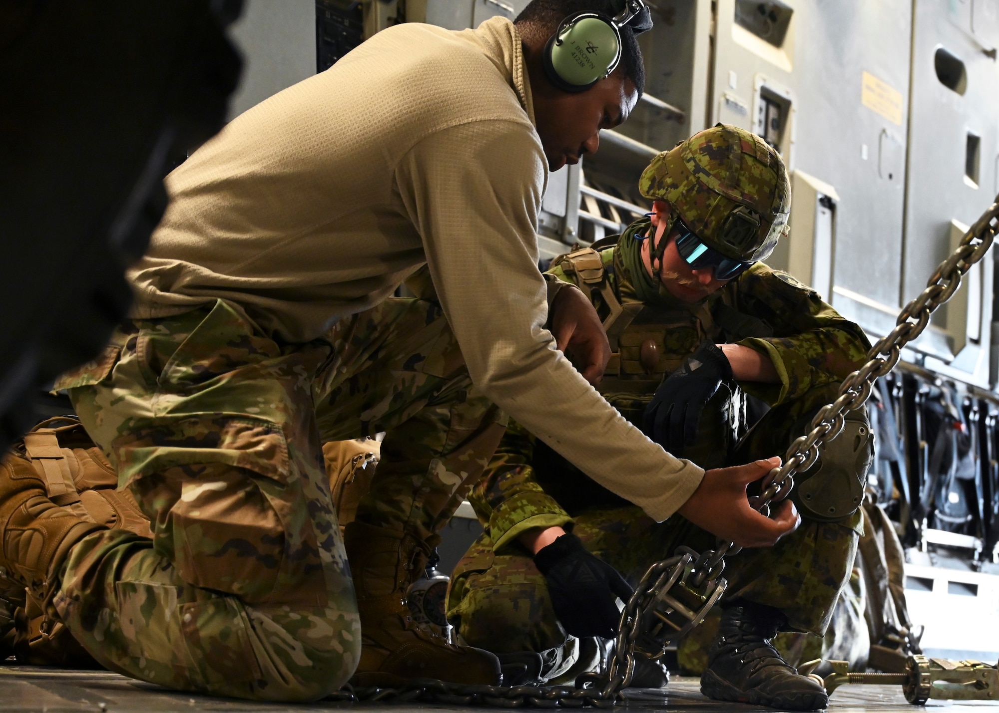 U.S. Air Force Senior Airman James Brown, communication/navigation journeyman with the 7th Expeditionary Airlift Squadron and an Estonian Division Artillery Battalion safety officer secure a high mobility artillery rocket system to a C-17 Globemaster III assigned to the 62d Airlift Wing, during Exercise Swift Response in Lielvarde, Latvia, May 14, 2023. Swift Response is an exercise related to DEFENDER 23. DEFENDER 23 is a U.S. Army Europe and Africa-led exercise, supported by U.S. Air Forces in Europe – Air Forces Africa, focused on the strategic deployment of continental United States-based forces and interoperability with Allies and partners. Taking place from April 22 to June 23, DEFENDER 23 demonstrates the U.S. Air Force’s ability to aggregate U.S.-based combat power quickly in Europe; increase lethality of the NATO Alliance through the U.S. Air Force’s Agile Combat Employment; build unit readiness in a complex joint, multinational environment; and leverage host nation capabilities to increase USAFE-AFAFRICA’s operational reach. DEFENDER 23 includes more than 7,800 U.S. and 15,000 multi-national service members from various Allied and partner nations. (U.S Air Force photo by Senior Airman Callie Norton)
