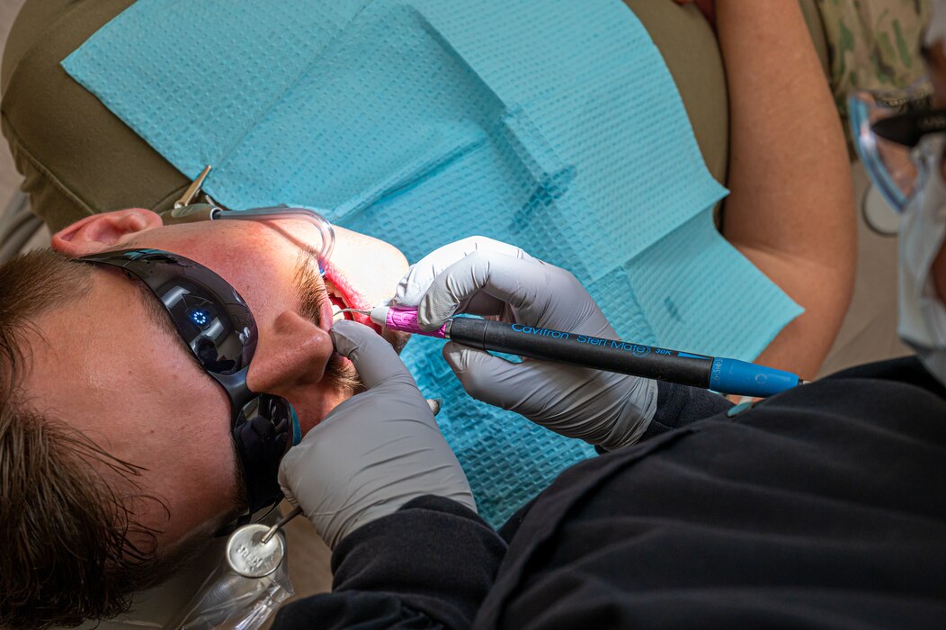U.S. Air Force Senior Airman Thalia Morales-Diaz, 5th Medical Group dental technician, checks the gum health of a patient's mouth during a routine dental check-up at Minot Air Force base, North Dakota, April 27, 2023. Dental technicians ensure that patients remain healthy and comfortable at all times. (U.S. Air Force photo by Airman 1st Class Nottingham)