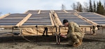 U.S. Air Force Senior Airman John Damouni, a water and fuel systems maintenance journeyman assigned to 773rd Civil Engineer Squadron, secures a solar panel system during an Agile Combat Employment air transportable clinic set up, during Northern Edge 23-1 at Joint Base Elmendorf-Richardson, Alaska, May 9, 2023. NE 23-1 is one in a series of U.S. Indo-Pacific Command exercises designed to sharpen the joint forces’ skills; to practice tactics, techniques, and procedures; to improve command, control and communication relationships; and to develop cooperative plans and programs.