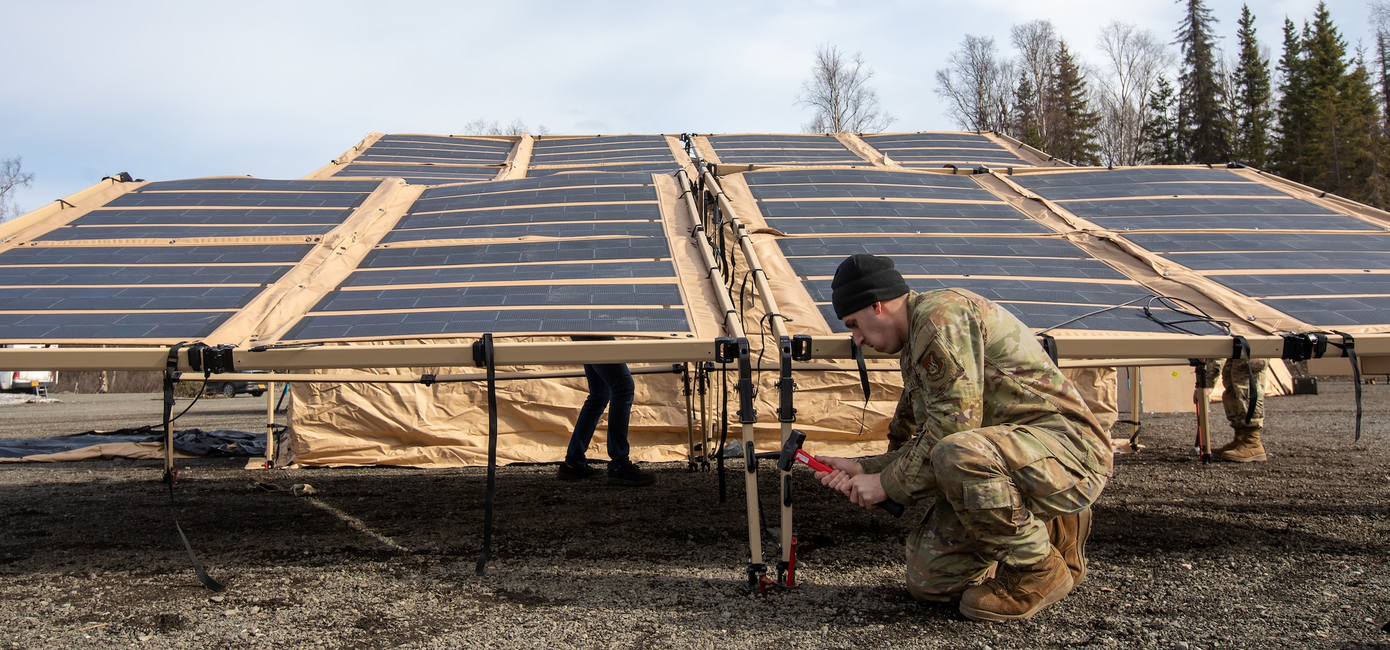 U.S. Air Force Senior Airman John Damouni, a water and fuel systems maintenance journeyman assigned to 773rd Civil Engineer Squadron, secures a solar panel system during an Agile Combat Employment air transportable clinic set up, during Northern Edge 23-1 at Joint Base Elmendorf-Richardson, Alaska, May 9, 2023.