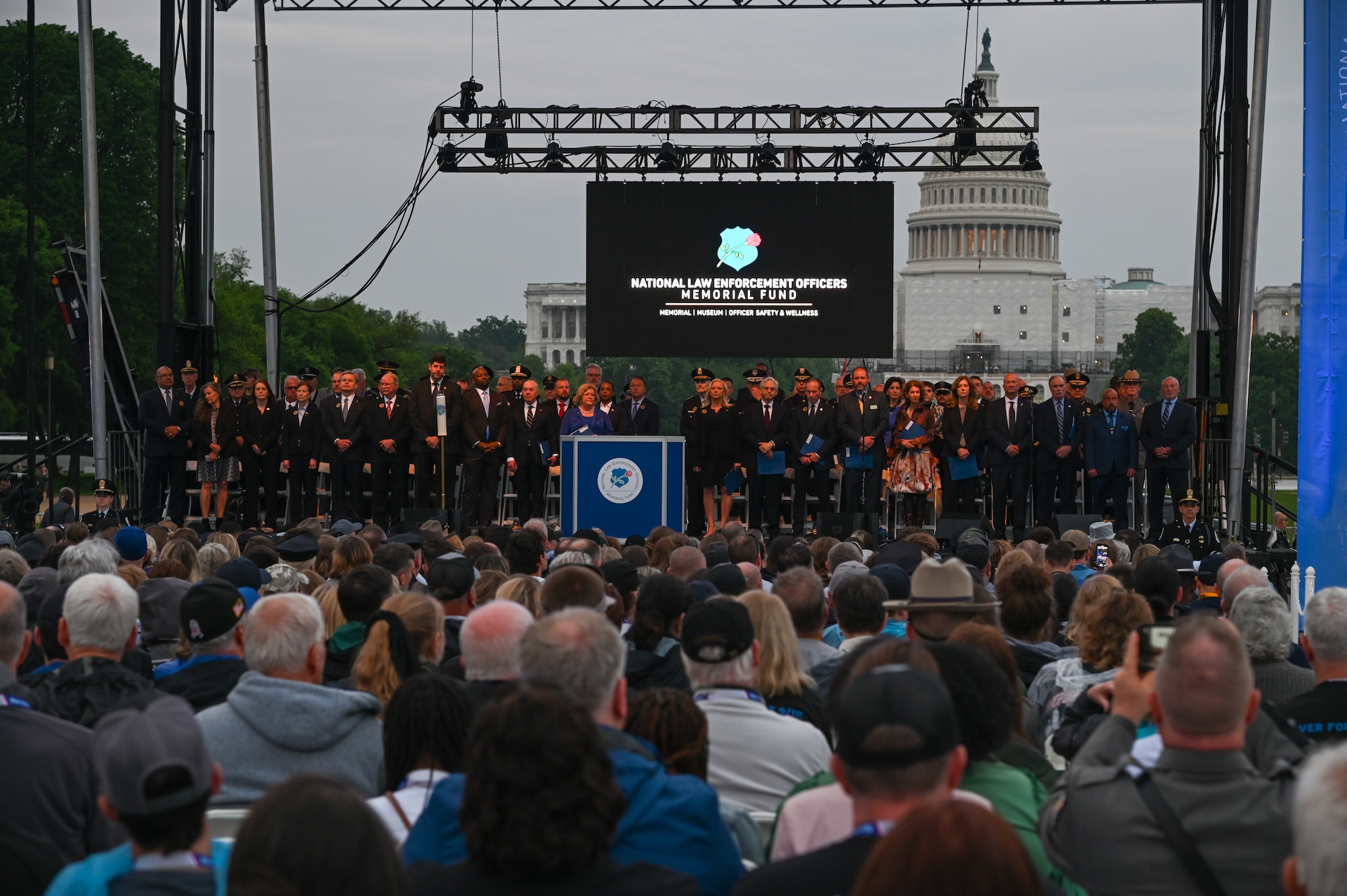 Members of the National Law Enforcement Officer Memorial Fund board and guest speakers stand at the 35th annual candlelight vigil at the National Mall in Washington, D.C. May 13, 2023. The vigil recognized law enforcement officers killed in the line of duty whose names were dedicated on the National Law Enforcement Memorial in Washington, D.C. Five hundred and fifty-six names were read aloud in front of a crowd of thousands. (U.S. Air Force photo by Abigail Meyer)