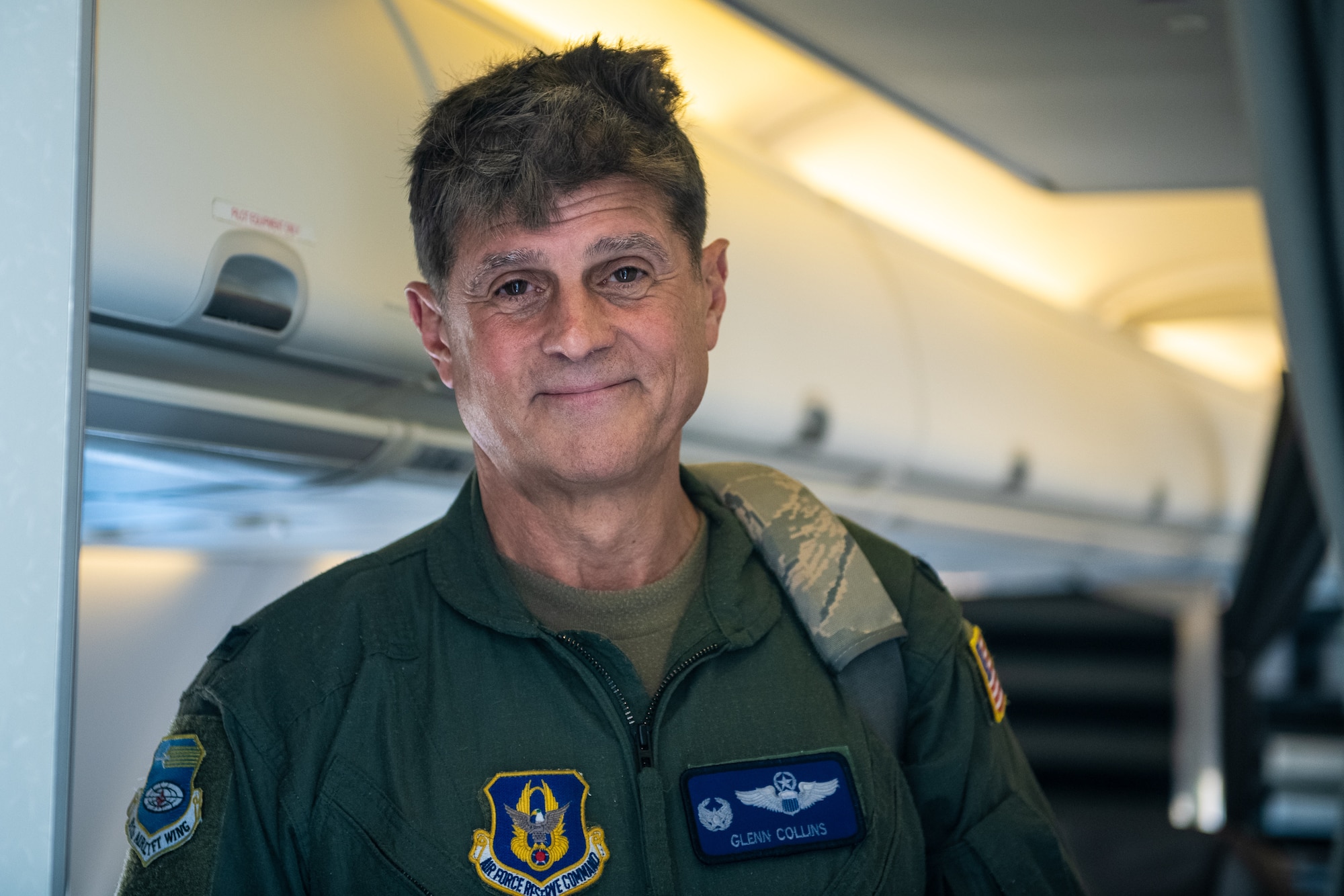 Col. Glenn Collins, 932nd Airlift Wing commander, poses for a photo in the passenger cabin of a C-40C Clipper aircraft upon the conclusion of his fini flight at Scott Air Force Base, Ill., May 24, 2023.