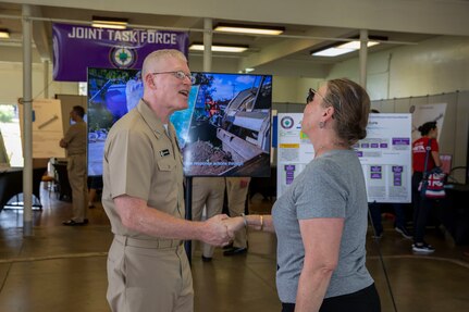 Joint Task Force-Red Hill (JTF-RH) Commander, U.S. Navy Vice Adm. John Wade, greets a local resident during JTF-RH’s Defueling Open House on Ke’ehi Lagoon Memorial in Honolulu, Hawaii, May 24, 2023.