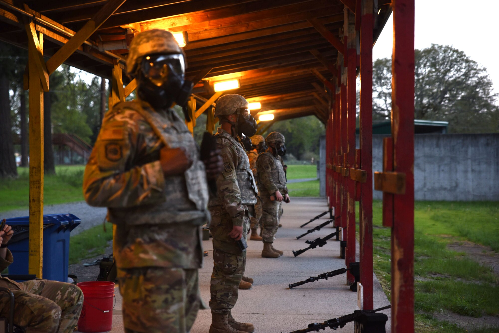 Team McChord Airmen prepare for a weapons qualification training at Joint Base Lewis-McChord, Washington, May 10, 2023. Airmen are required to qualify while wearing a gas mask to ensure they can perform in the event of a real-world situation. (U.S. Air Force photo by Airman 1st Class Kylee Tyus)