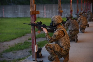 Team McChord Airmen prepare to fire weapons during weapons qualifications training at Joint Base Lewis McChord, Washington, May 10, 2023. Weapons qualifications are held to ensure service members are deployment ready. (U.S. Air Force photo by Airman 1st Class Kylee Tyus)