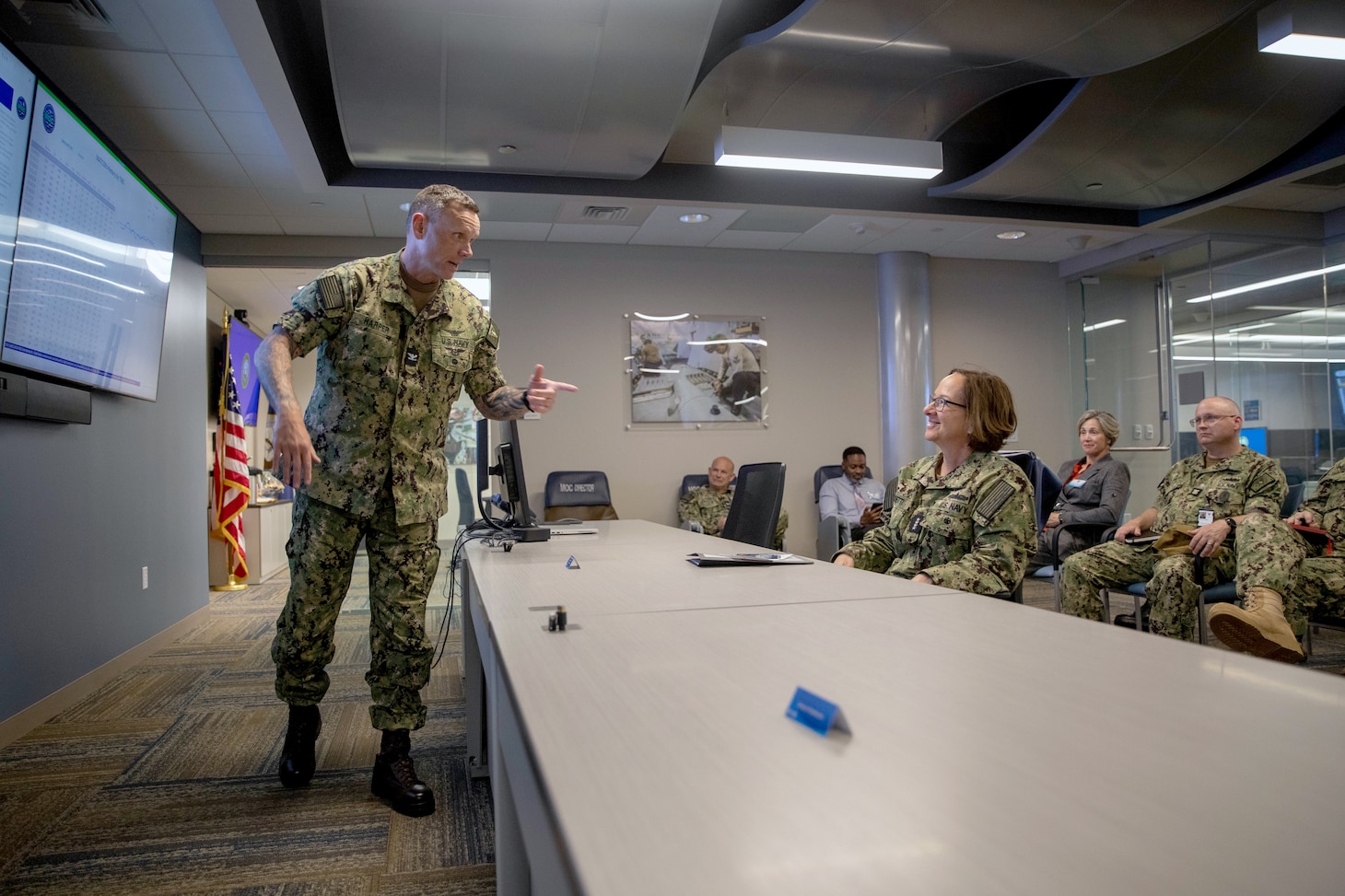 Vice Chief of Naval Operations Adm. Lisa Franchetti, listens to Capt. Ronnie Harper, director of the Maintenance Operation Center.