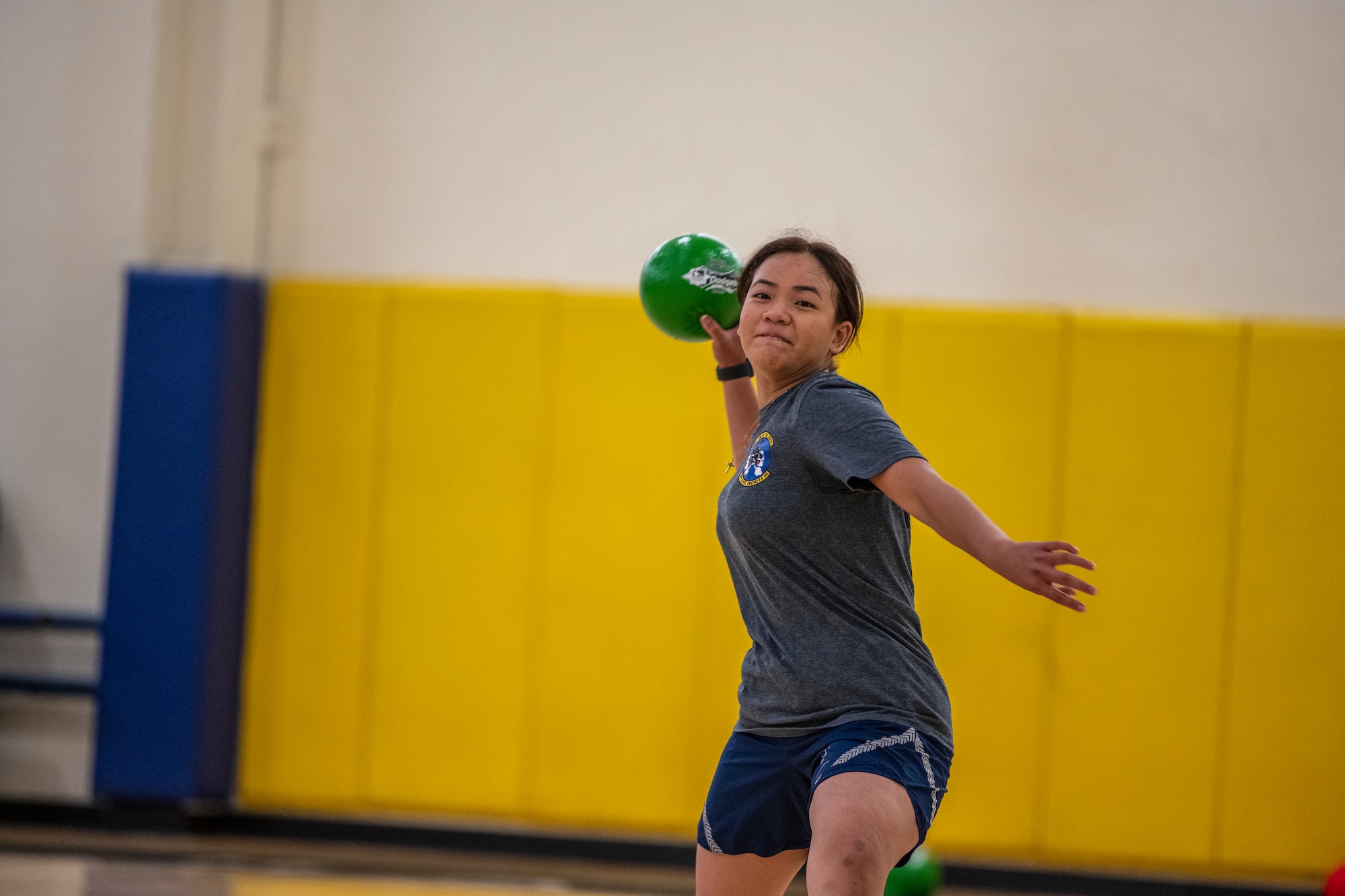 A woman throws a dodgeball