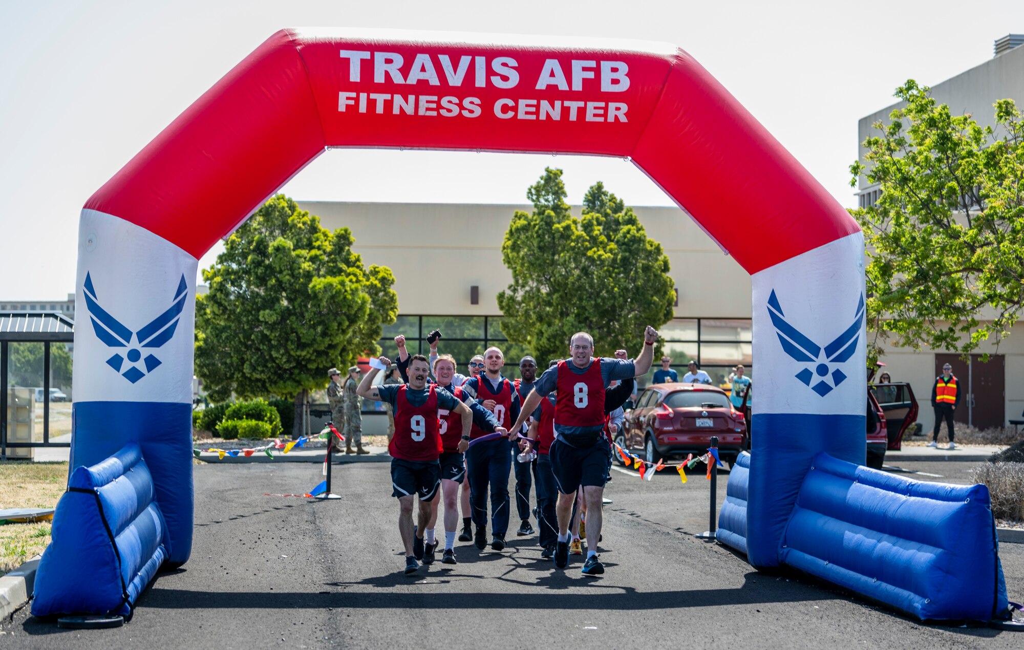 People run together over a finish line.