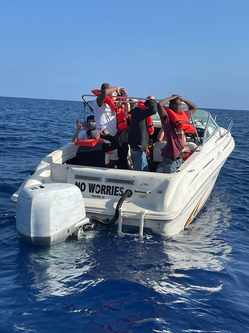 Migrants await being transferred from a 30-foot pleasure craft about 25 miles east of St. Luice, Florida, May 17, 2023. The vessel became disabled, and Customs and Border Protection and Coast Guard personnel discovered 13 people on board attempting to migrate unlawfully to the U.S. (U.S. Coast Guard photo).