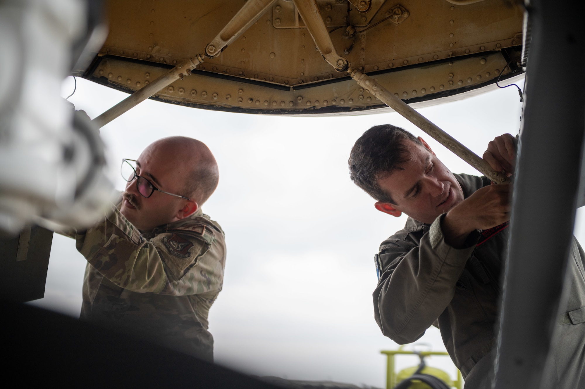 Airmen inspect plane