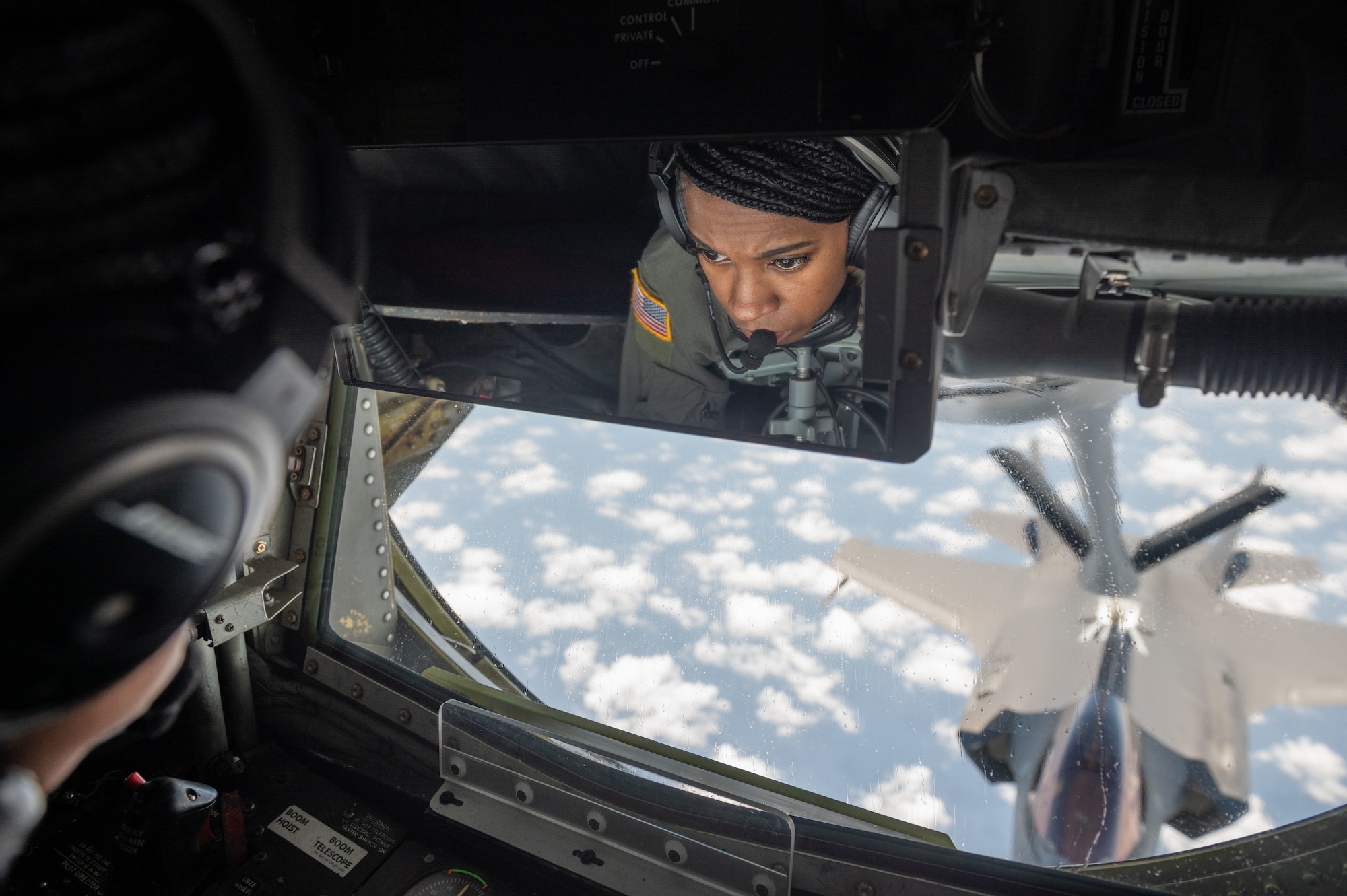 Airman fuels a jet in the air