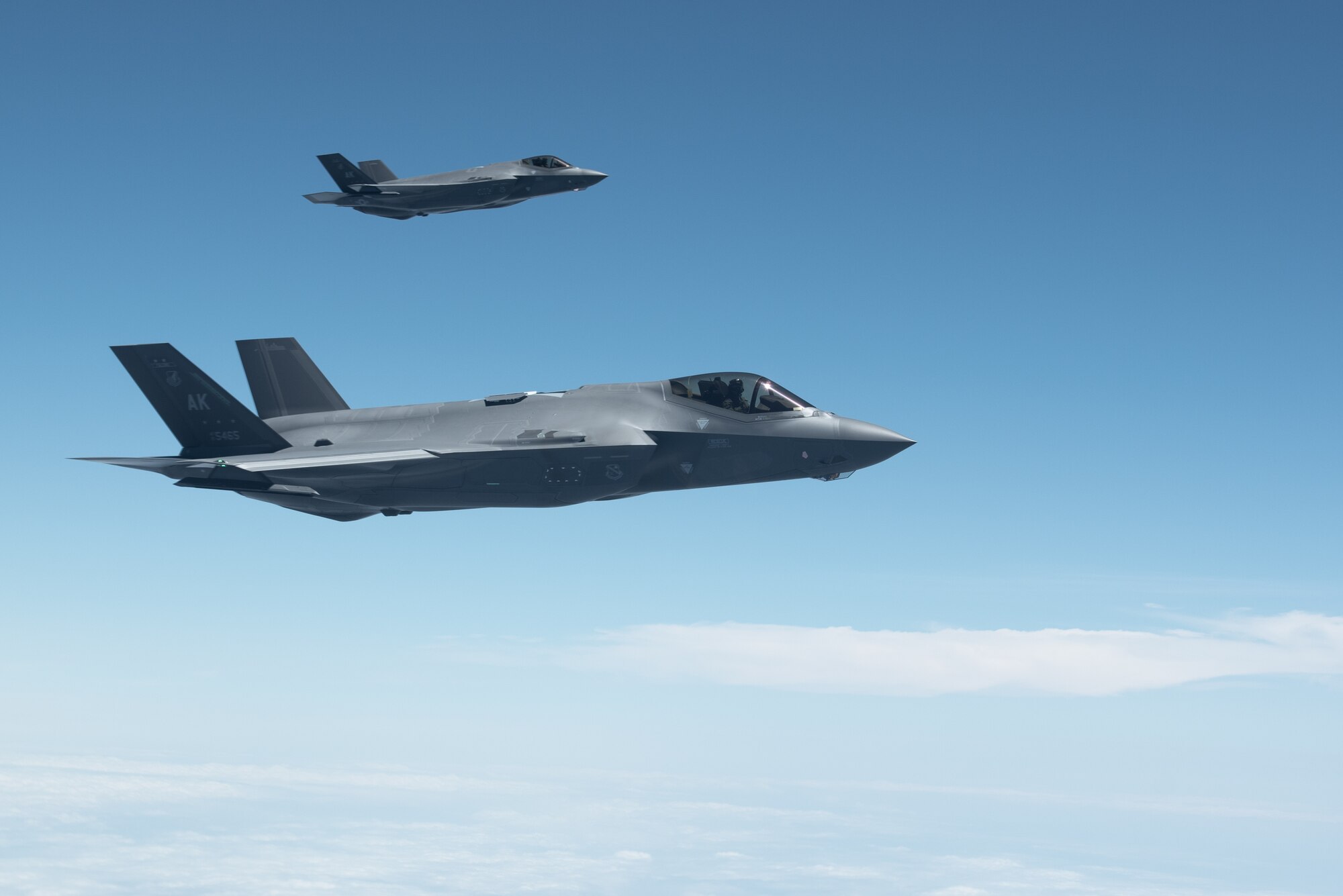 jet flies next to another jet