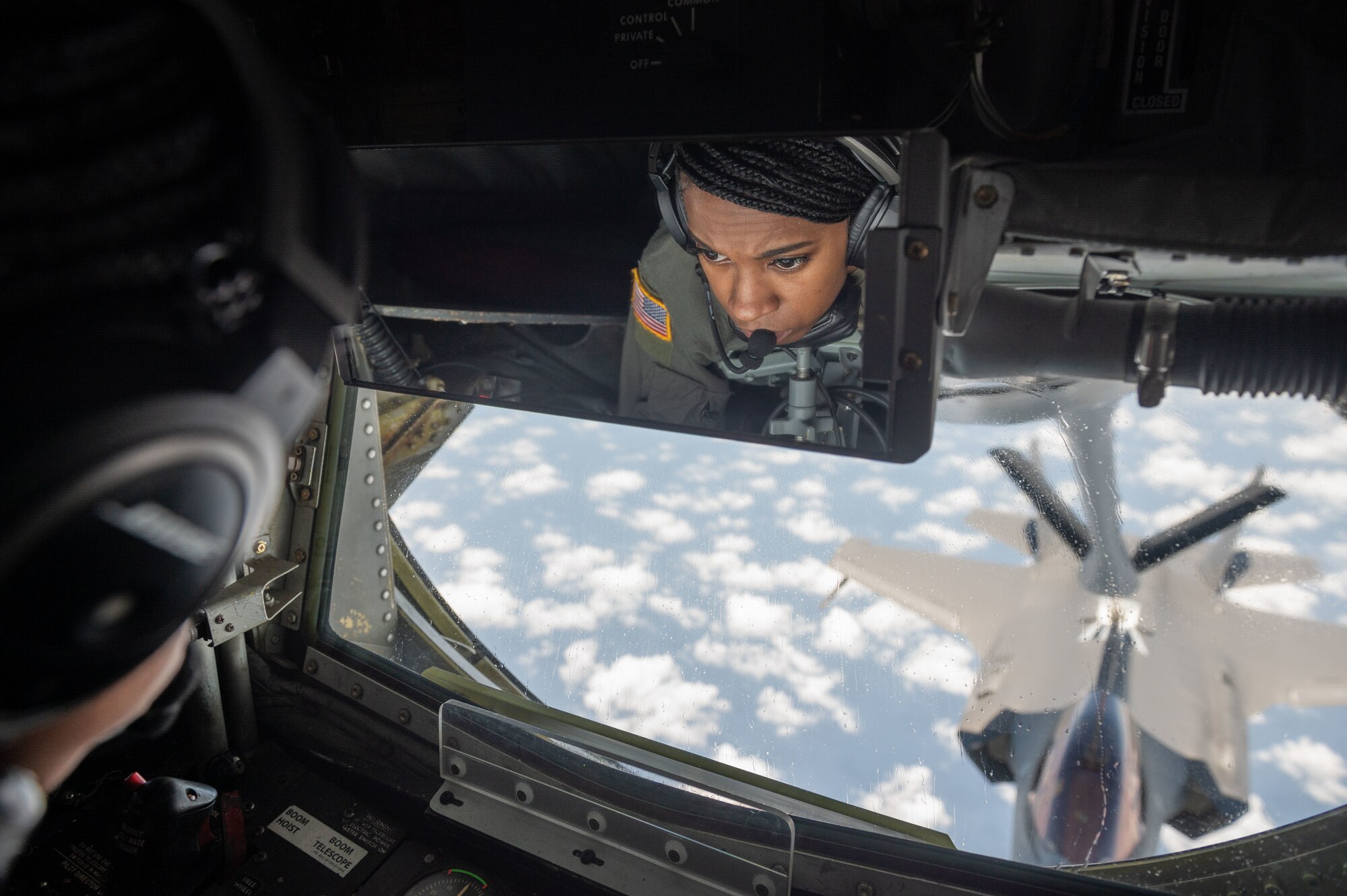 Airman fuels a jet in the air