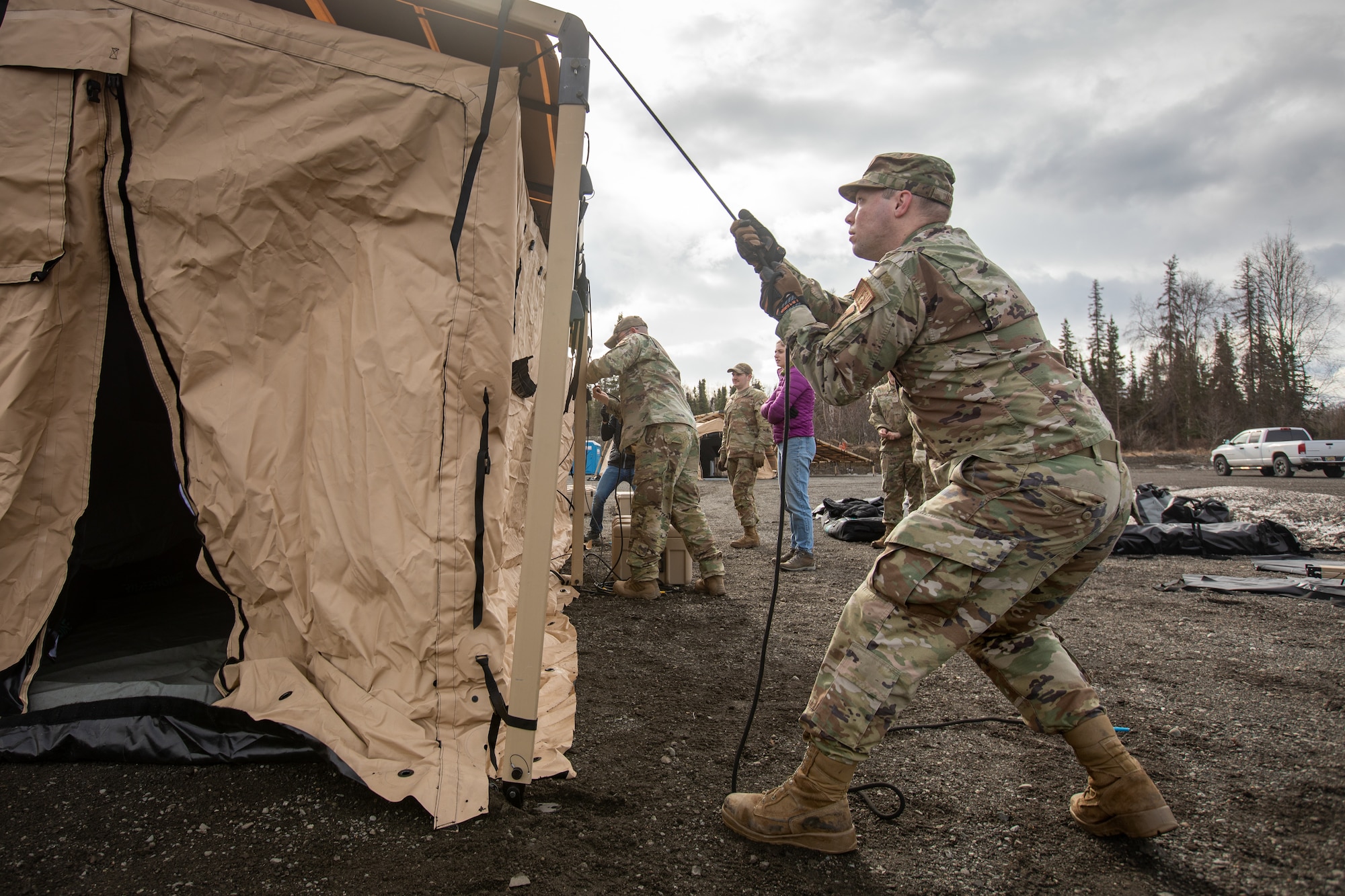 U.S. Air Force Airman 1st Class Matthew Jaeger, right, a water and fuel systems maintenance journeyman assigned to 773rd Civil Engineer Squadron, erects an Agile Combat Employment air transportable clinic tent, during Northern Edge 23-1 at Joint Base Elmendorf-Richardson, Alaska, May 9, 2023.