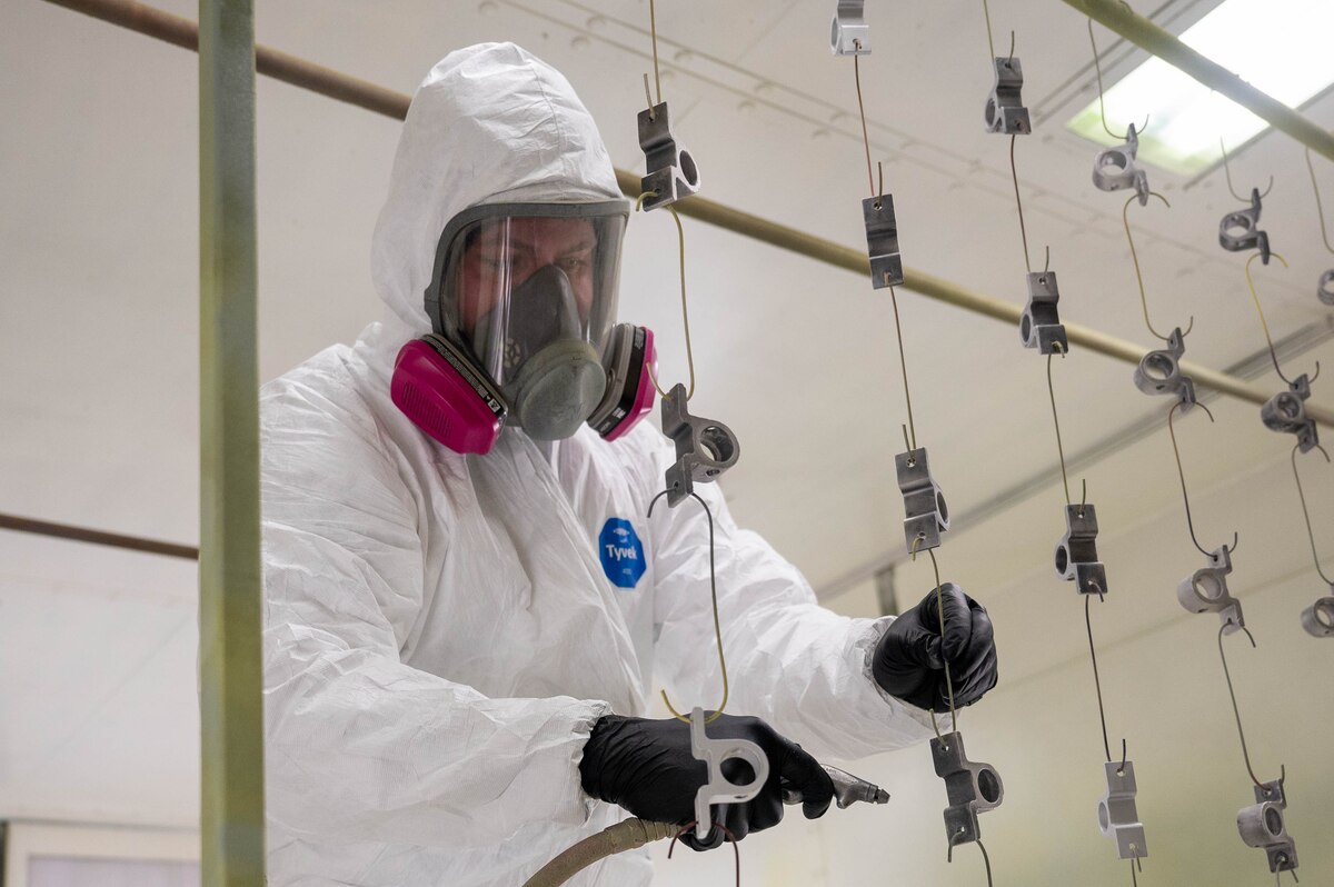 Staff Sgt. Tanner Tschann, 934th Maintenance Squadron aircraft structural maintenance technician, air blasts aircraft parts at the Minneapolis-St. Paul Air Reserve Station, Minnesota, May 6, 2023. This step in the paint application process is to ensure parts are cleared of debris so the paint solution will coat properly. (U.S. Air Force photo by Senior Airman Colten Tessness)