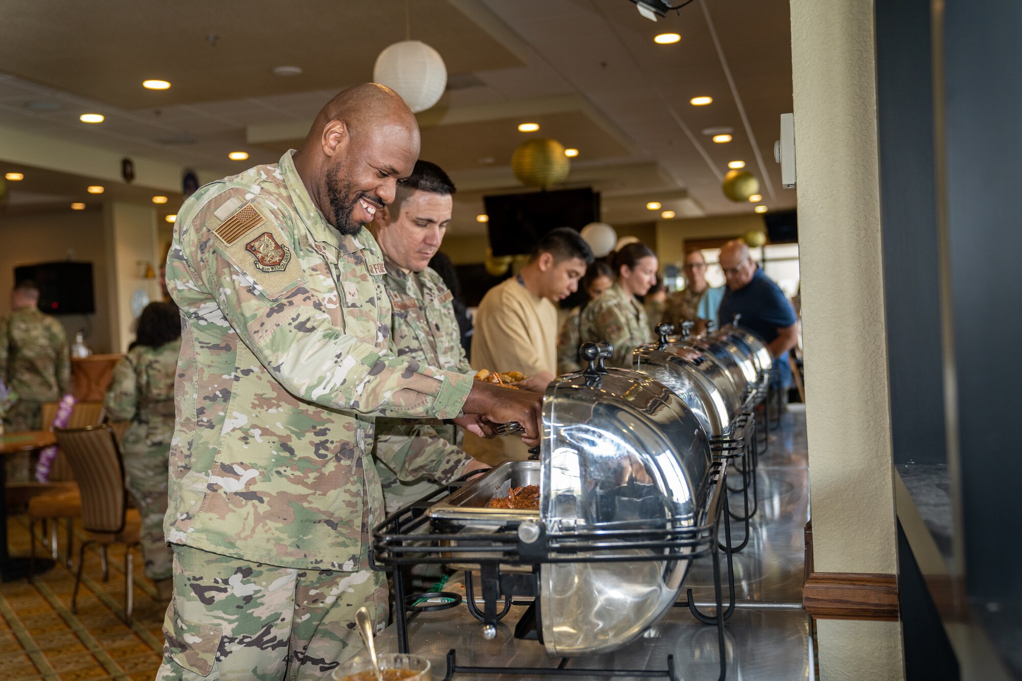 Airmen from the 81st Training Wing help themselves to cultural dishes during the Asian American and Pacific Islander Heritage Month social event at Keesler Air Force Base, Mississippi, May 24, 2023.