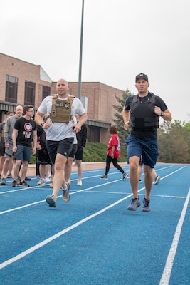 U.S. Space Force Col. Christopher Fernengel, left, sports a 20-lbs vest during Delta 3's Memorial Day workout.