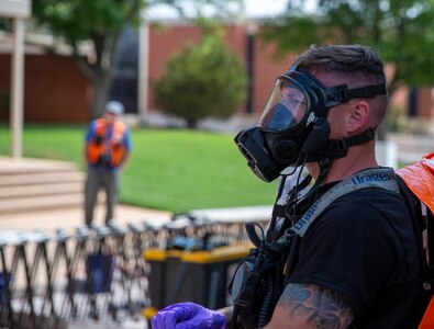 Oklahoma Army National Guardsman, Staff Sgt. Willard Casey, member of the 63rd Civil Support Team, dons his protective gear during a training exercise in Weatherford, Oklahoma, May 23, 2023. In a joint effort to enhance emergency response capabilities, the Oklahoma National Guard's 63rd CST collaborated with local first responders during a full-scale exercise held in Custer and Washita County and the City of Weatherford, May 23-25, 2023. The comprehensive exercise provided an invaluable opportunity for all participants to enhance their coordination, communication, and response capabilities. (Oklahoma National Guard photo by Leanna Maschino)