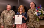 Melissa Mahoney, wife of newly-retired Lt. Col. Brian Maloney, receives a Certificate of Appreciation during a retirement ceremony May 5 at Camp Lincoln, Springfield, Illinois.