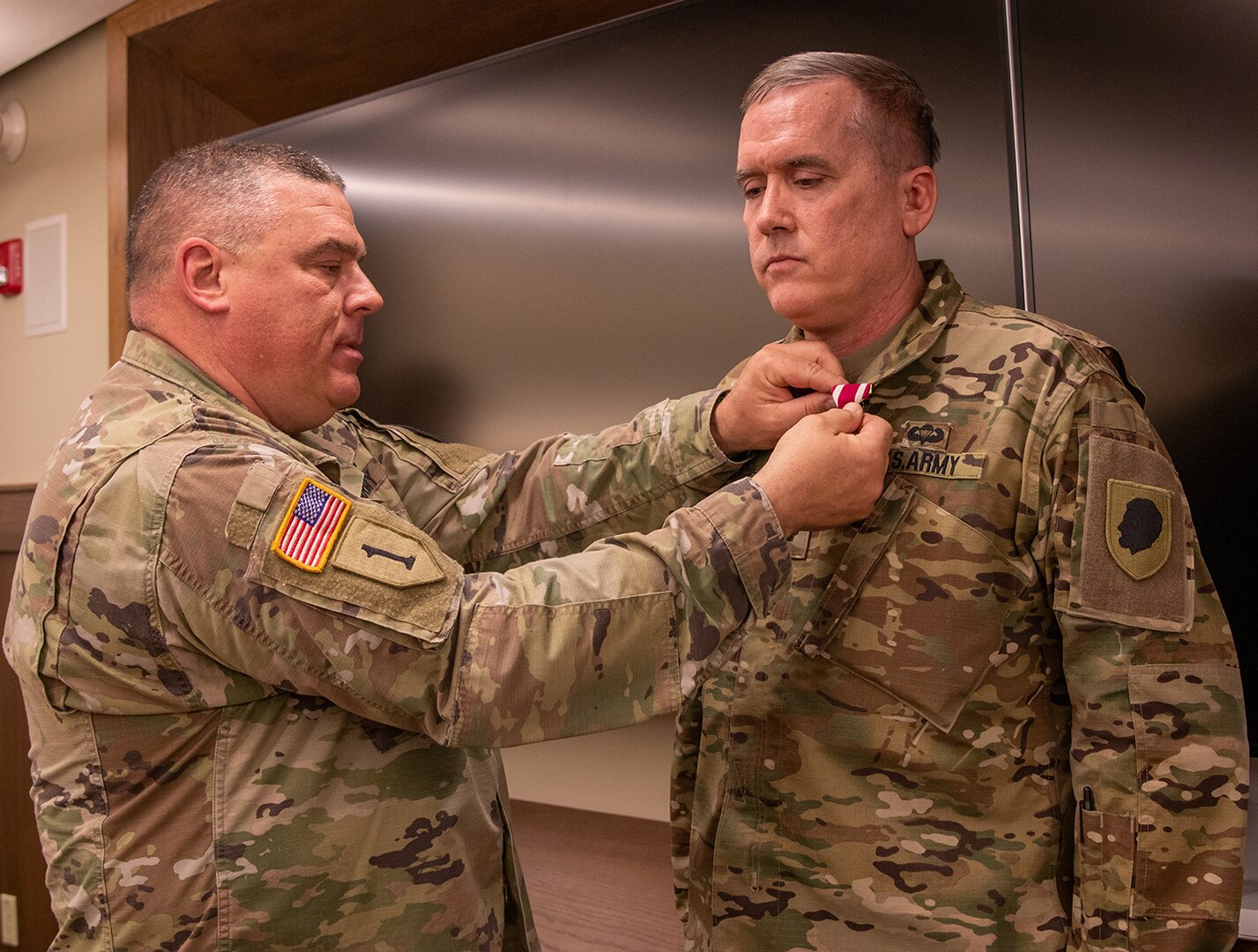 Illinois Army National Guard Lt. Col. Brian Maloney, of Champaign, Illinois, Comptroller, United States Property and Fiscal Office (USPFO), receives the Meritorious Service Medal, from Col. Brian Creech, the USPFO of Illinois, during a retirement ceremony at Camp Lincoln, Springfield, Illinois, May 5.