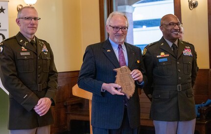Maj. Gen. Rodney Boyd, Assistant Adjutant General – Army and Commander of the Illinois Army National Guard, and Col. Michael Eastridge, former commander of the 33rd Infantry Brigade Combat Team, present Patrick Van Nevel, Honorary Consul of the Kingdom of Belgium, with a plaque commemorating the shared history between the Illinois National Guard and Belgium.