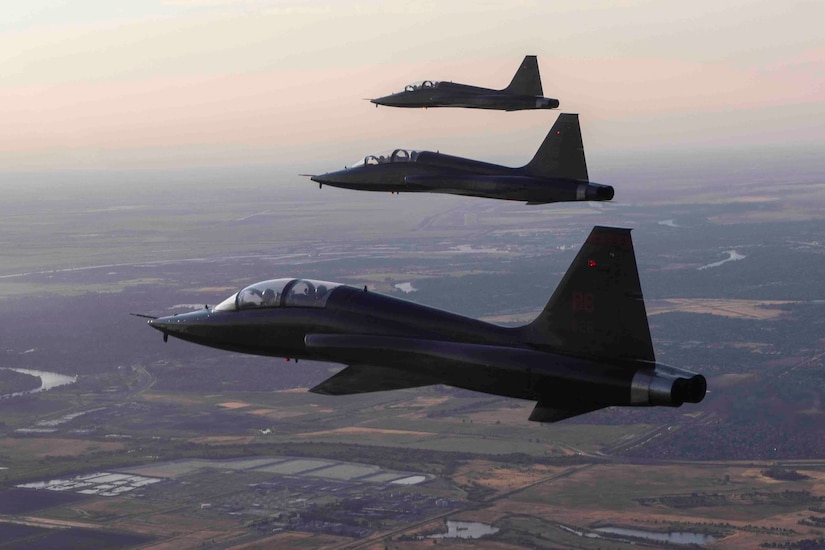 Three fighter aircraft fly in formation.