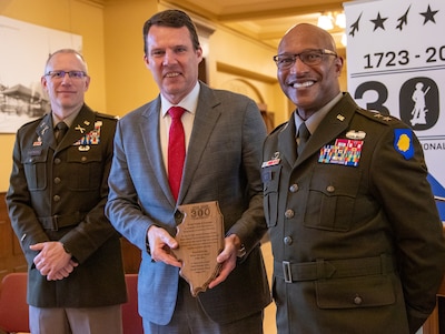 Maj. Gen. Rodney Boyd, Assistant Adjutant General – Army and Commander of the Illinois Army National Guard, and Col. Michael Eastridge, former commander of the 33rd Infantry Brigade Combat Team, present Chris Elstoft, Consul General of Australia in Chicago, with a plaque honoring the shared history between the Illinois National Guard and Australia.