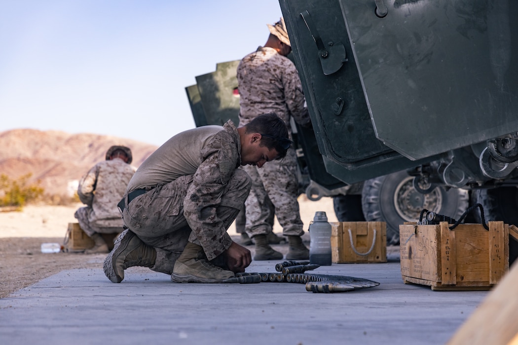 A U.S. Marine rearranges rounds of 25mm during the 2023 Bushmaster Challenge at Marine Corps Air-Ground Combat Center
