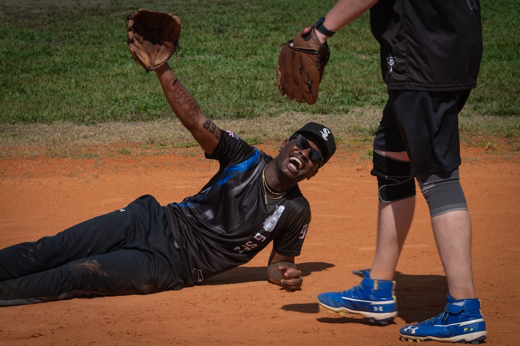 A player on the 6th Security Forces softball team “Gobblers” laughs