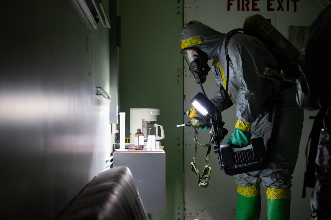 U.S. Air Force Senior Airman Chase McAvaney, 18th Civil Engineer Squadron Chemical, Biological, Radiological and Nuclear element team member, scans a room for hazardous elements