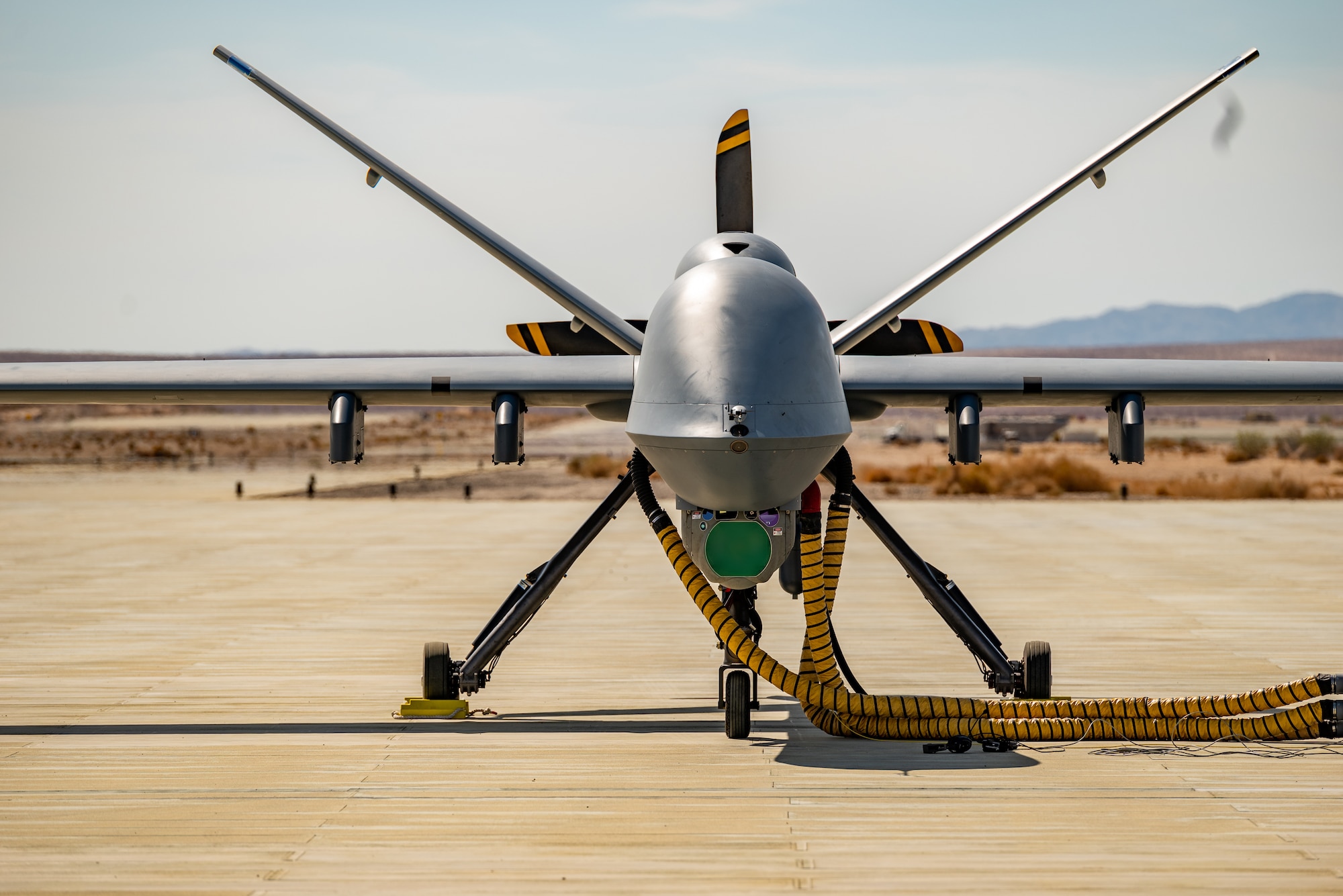 An MQ-9 Reaper assigned to the 163 Attack Wing, March Air Reserve Base stages for refueling on the Strategic Expeditionary Landing Field on Marine Corps Air Ground Combat Center Twentynine Palms, CA July 20, 2022. (U.S. Air National Guard photo by Staff Sgt. Joseph Pagan)