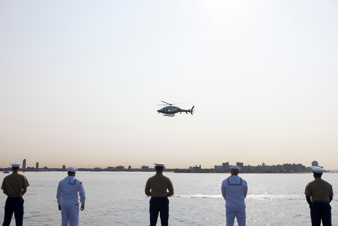 U.S. Marines and U.S. Navy Sailors with Special Purpose Marine Air-Ground Task Force – New York and Sailors with Wasp-Class Amphibious Assault Ship USS WASP (LHD-1), man the rails during the parade of ships as part of Fleet Week New York 2023 (FWNY 23), May 24, 2023. During FWNY 23 more than 3,000 service members from the Marine Corps, Navy, Coast Guard and our NATO allies from Great Britain, Italy and Canada are engaging in special events throughout New York City and the surrounding Tri-State Region, showcasing the latest capabilities of today’s maritime services and connecting with citizens. FWNY events include free public ship tours, military static displays, and live band performances and parades. (U.S. Marine Corps photo by Lance Cpl. Jessica J. Mazzamuto)