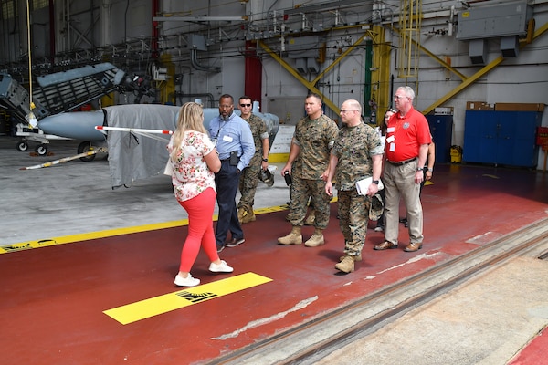 Capability Management Branch Head Heather Carlson, left, of the Fleet Readiness Center East (FRCE) Central Coordination Department, escorts a group of leaders from Marine Depot Maintenance Command (MDMC) including Commander Col. Kirk M. Spangenberg, second from right, and Deputy Commander Vincent Hutcherson, second from left, during a May 17 tour of the depot. MDMC leaders visited FRCE in order to learn more about FRCE’s innovative solutions to common challenges shared by the two commands and share best practices.