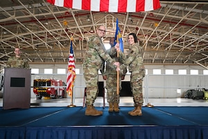 Maj. Jaime Smith receives the 914th Maintenance Squadron guidon flag, and thereby command of the 914 MXS, from Lt. Col. Keith McCray, 914th Maintenance Group commander.